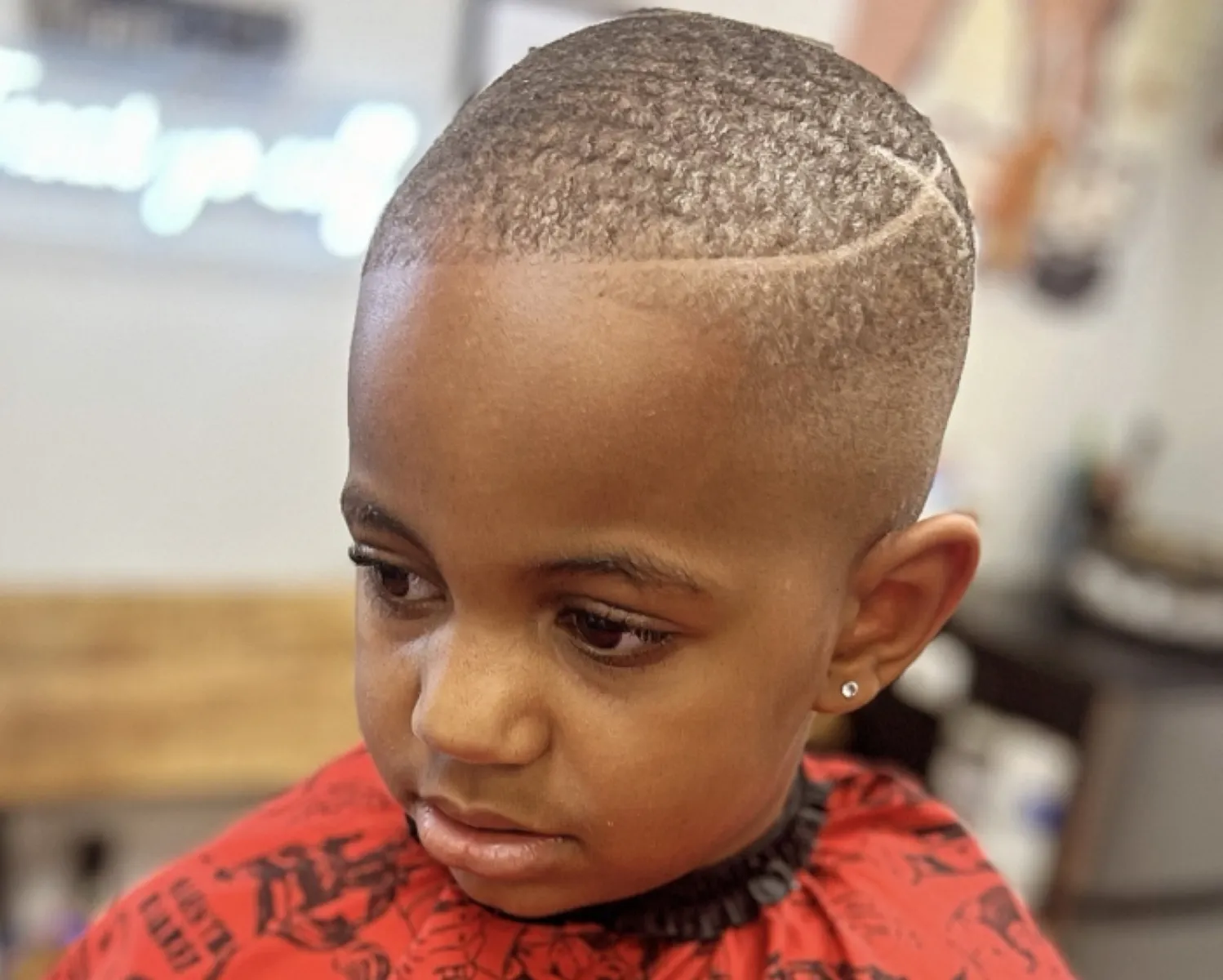 Kids cut with a curved part and crisp taper.