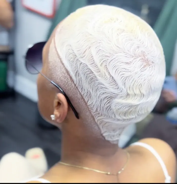 Platinum finger waves set into a sharp geometric ridge pattern.
