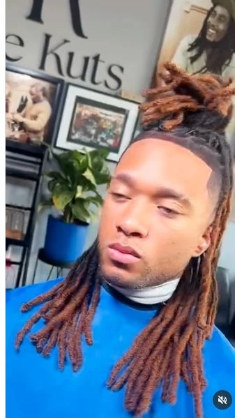 Long locs finished in a warm copper color.