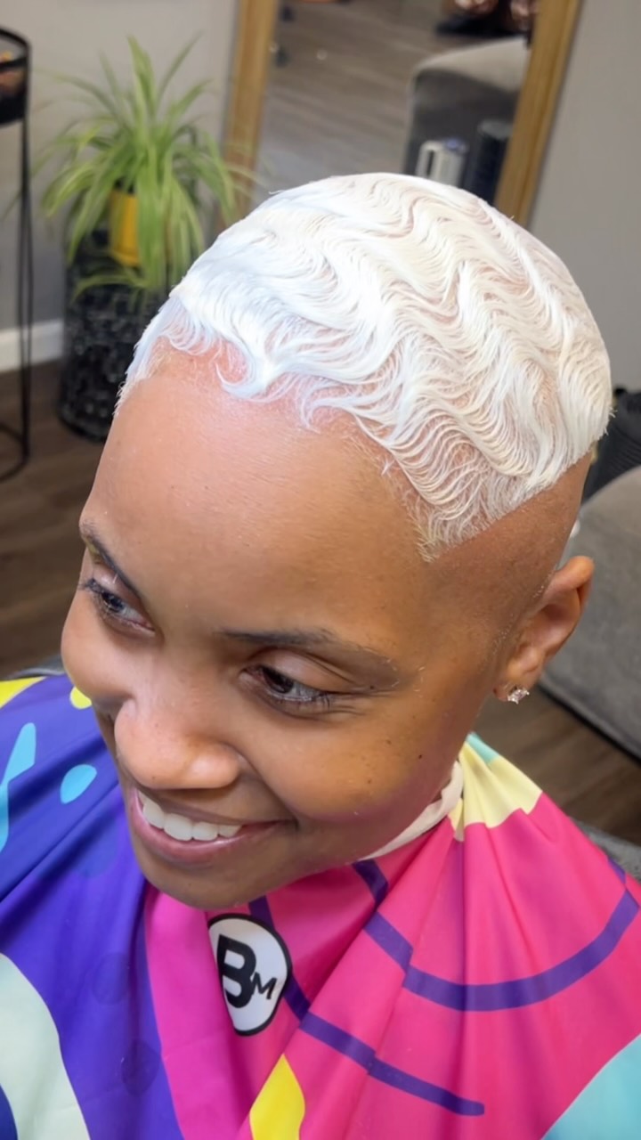 Platinum finger waves styled into an S-ridge pattern, smiling in the chair.