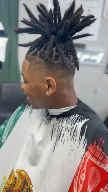 A loc updo paired with a faded undercut, side profile.
