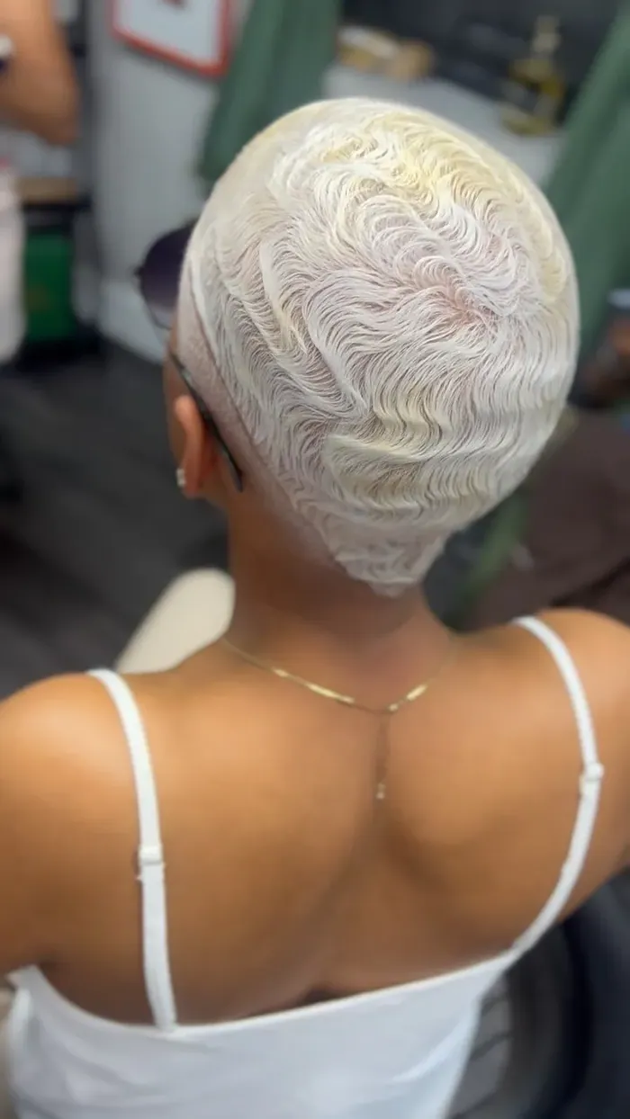 Platinum finger waves styled into a radiating ridge pattern, back view.