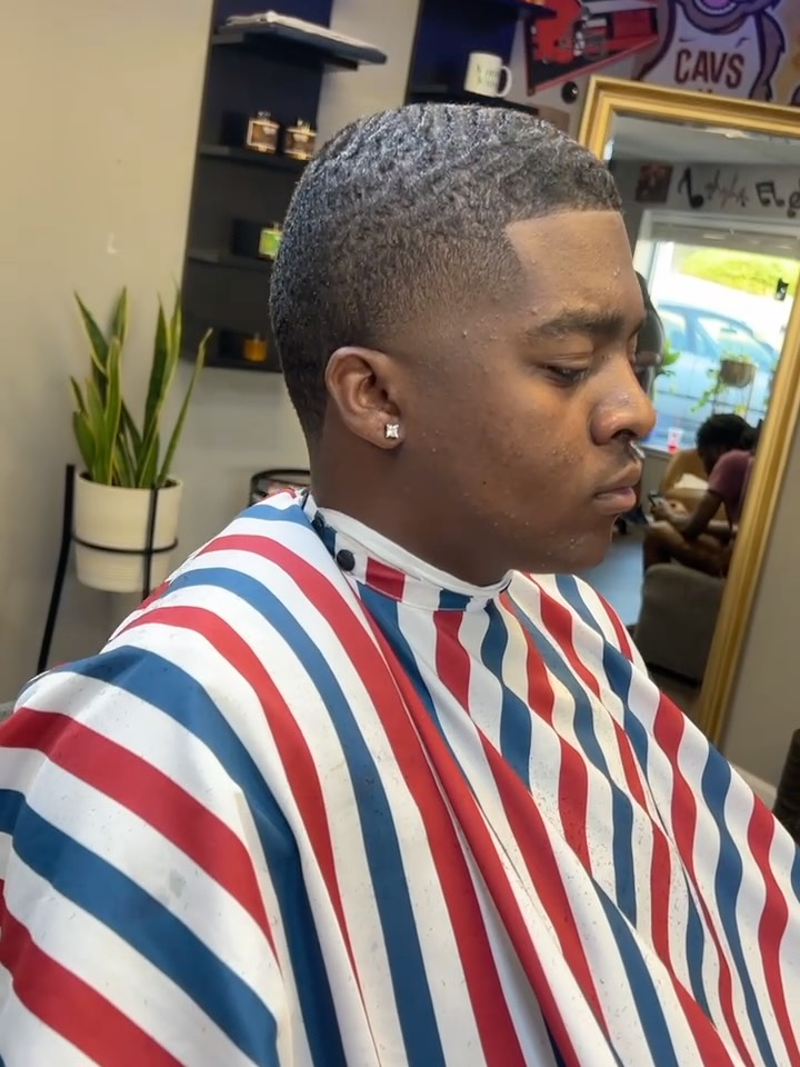 Taper fade with a sharp part line and low skin fade finish.